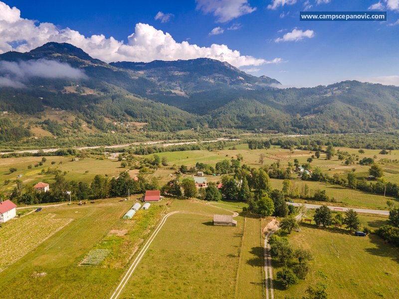 Wide aerial view of the Tara valley near the camp