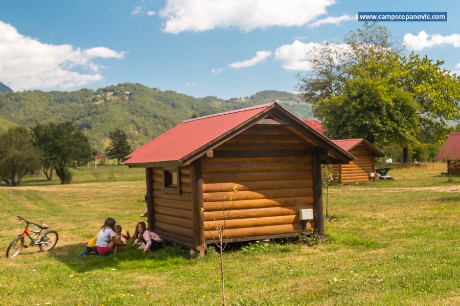 Wooden cabin in a green meadow
