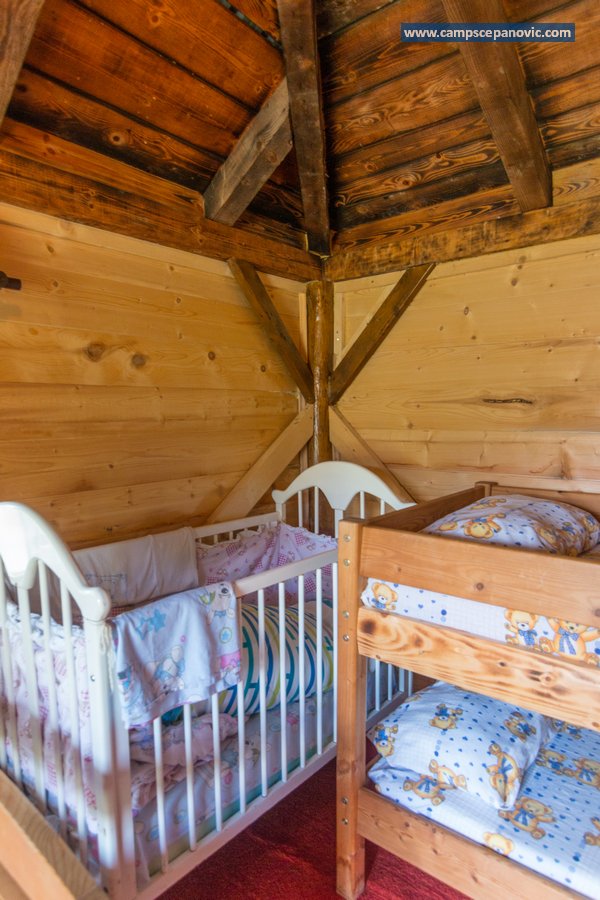 Cabin interior with baby cot and bunk bed