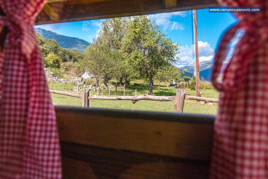 Mountain view framed by cabin curtains