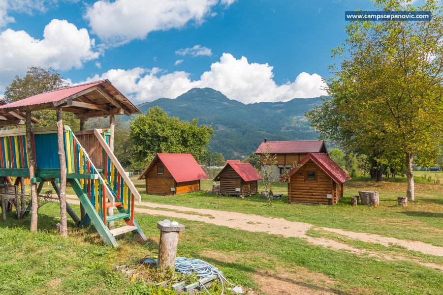 Cabins, playground and mountain view