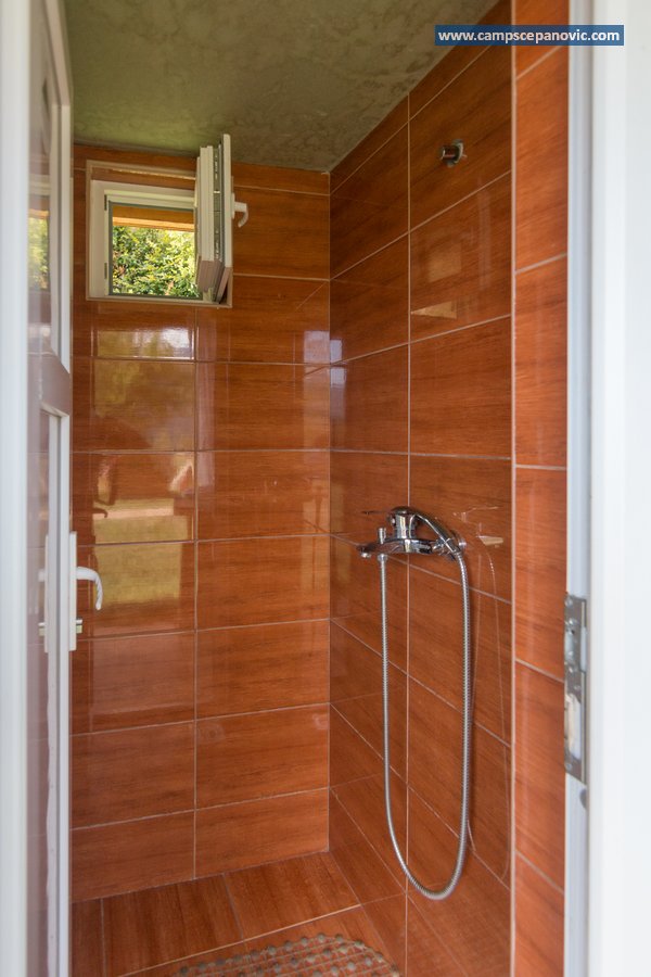 Clean camp shower with tiled walls